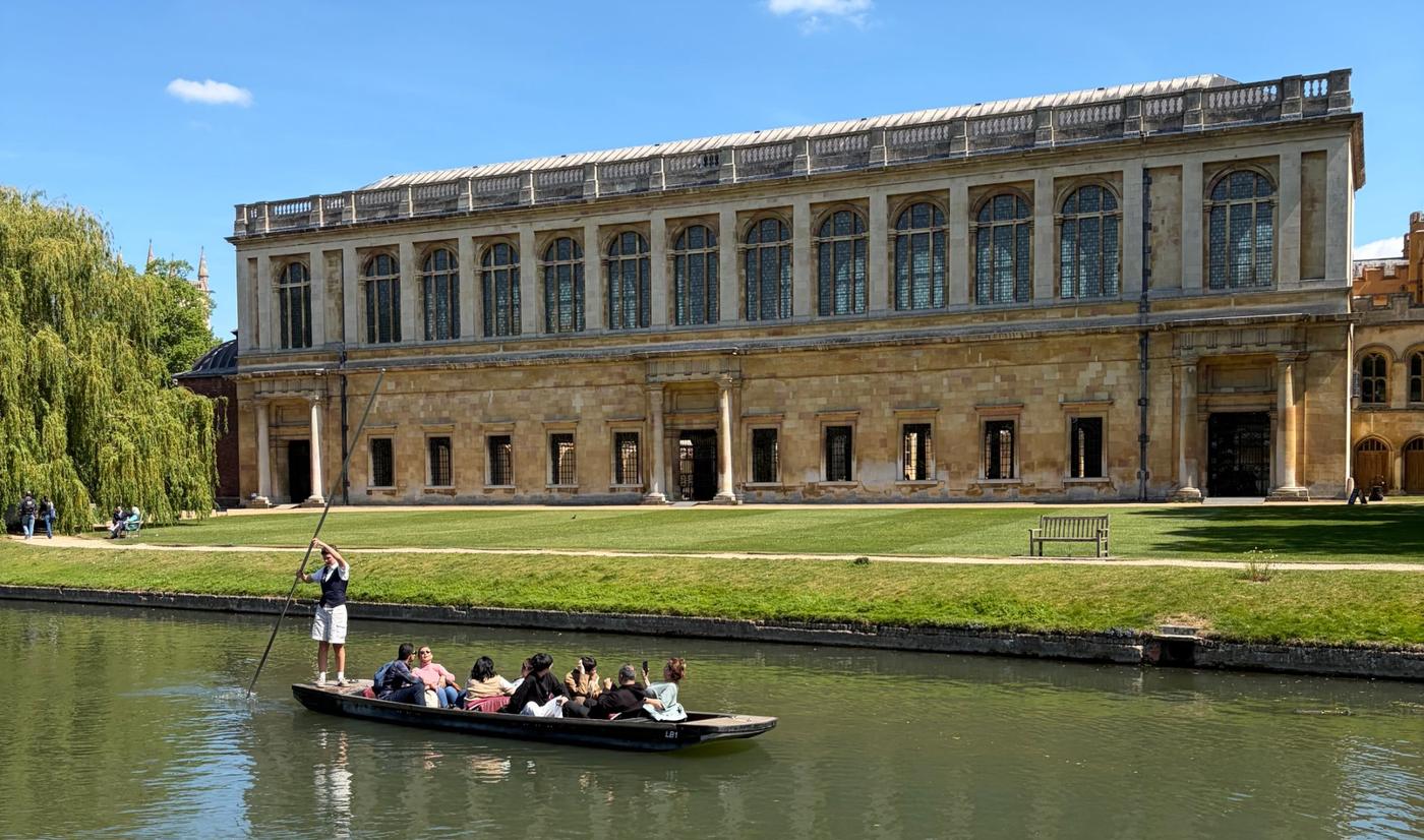 A punt on the River Cam in front of the Wren Library, Trinity College, Cambridge